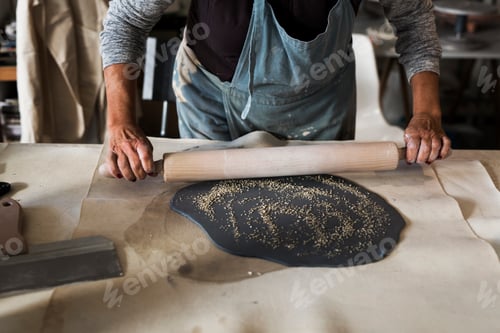 Preview: Mid section of potter preparing clay