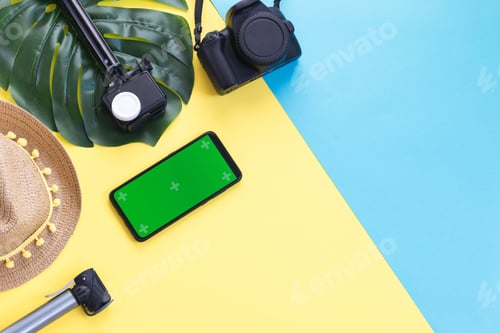 Preview: Two cameras, a straw hat, a manster leaf and a smartphone on a yellow background.