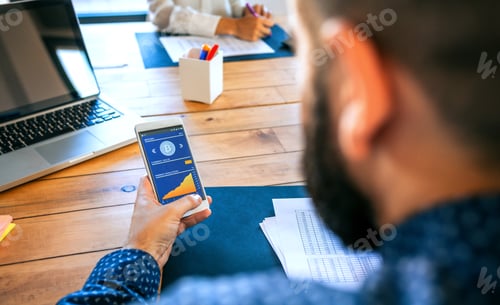 Preview: Businessman looking mobile with bitcoins information