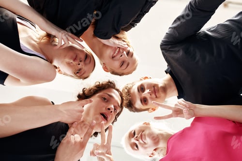 Preview: Team of people holding hands. Group of happy young women holding hands. Bottom view, low angle shot