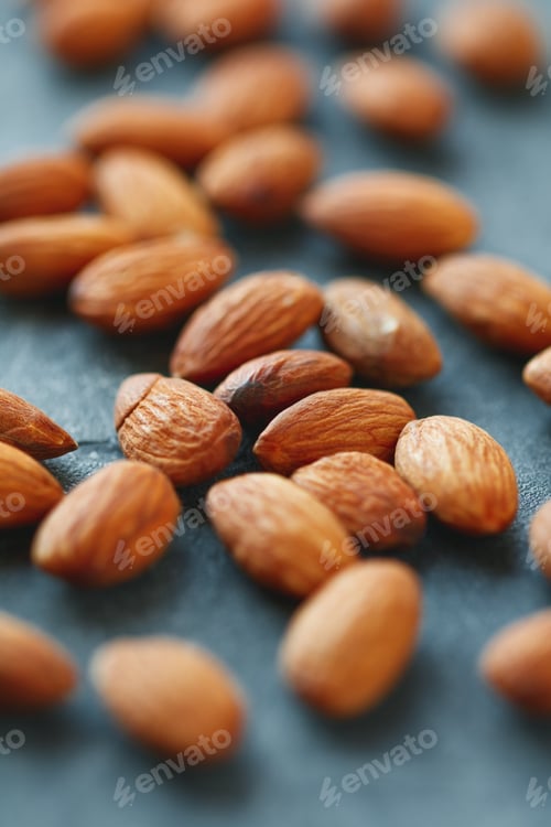 Preview: Almond nuts over grey background. The concept of healthy and organic food.