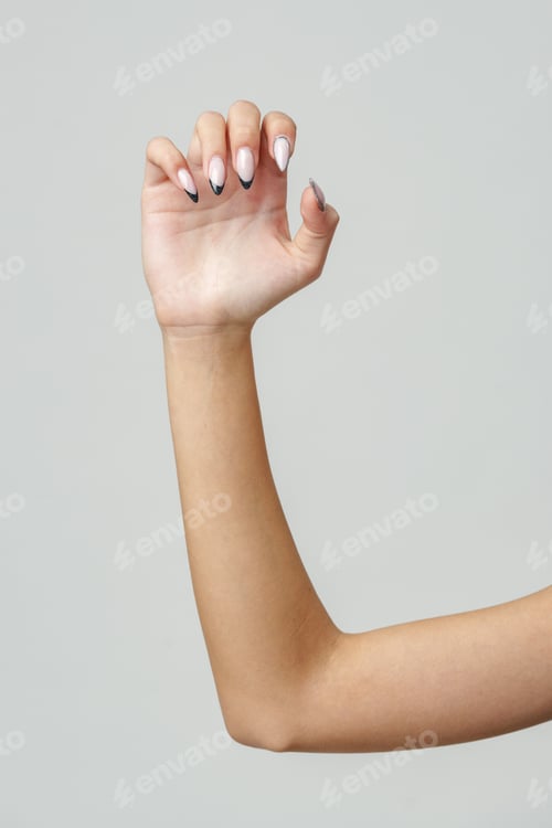 Preview: Woman's Arm Extended With Hand Open and Fingers Against a White Background