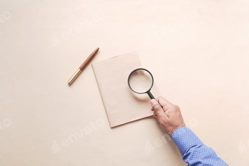 Preview: hand in magnifying glass inspecting 404 error.