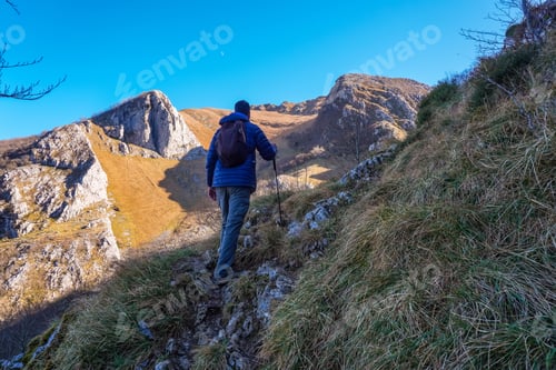 Preview: Hiker walking up mountain path on mount txindoki, basque country