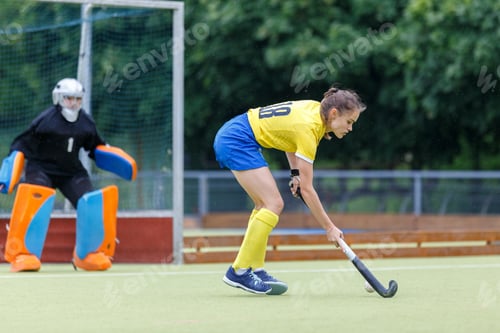 Preview: Young female field hockey player is going to score the goal