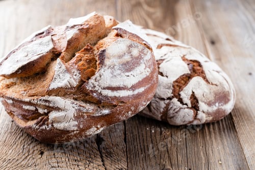 Preview: Bread background, top view of, black and rye loaves on black.