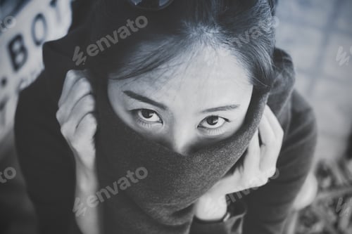 Preview: Black and white closeup image of a beautiful Asian woman looking and closing her mouth