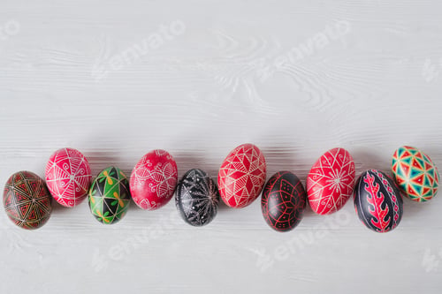 Preview: Colorful Easter eggs on white wooden background. Traditional Ukrainian pysanka handmade technique.
