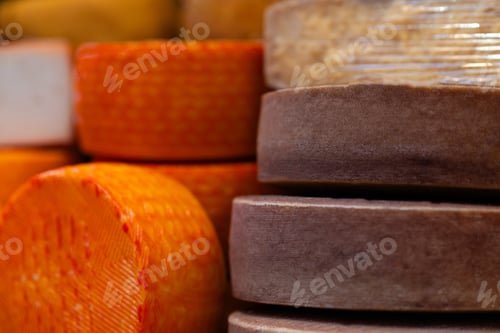 Preview: Stacked Wheels of Aged Cheese in Close-Up
