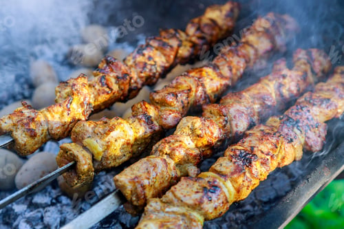 Preview: Grilled meat shish kebab on skewers outdoor.