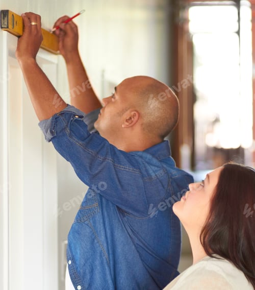 Preview: He knows his spirit level. Shot of a married couple doing some improvements on their home.