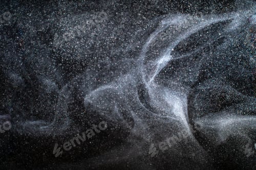 Preview: Dust particles cloud generating abstract shapes with black background and copy space for text.