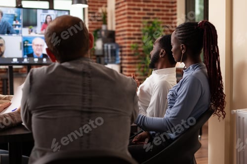 Preview: Diverse businesspeople discussing marketing statistics with remote entrepreneurs