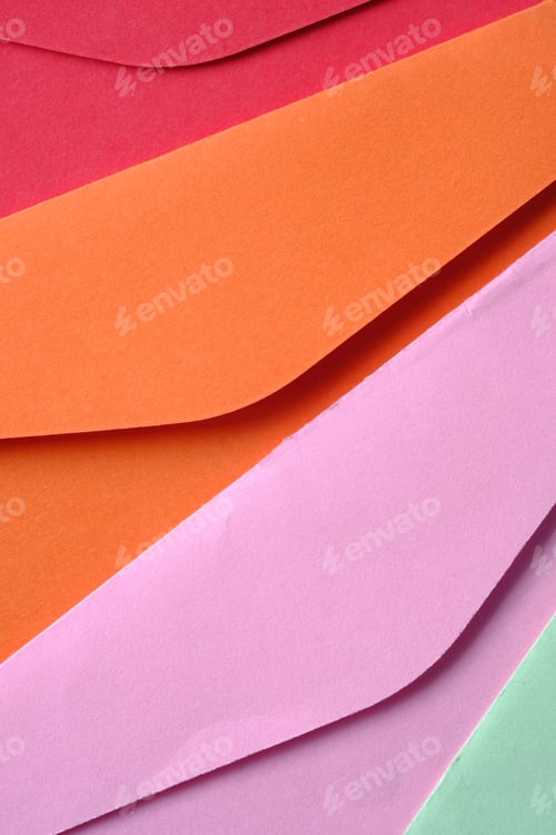 Preview: colorful envelope on pink background with copy space.