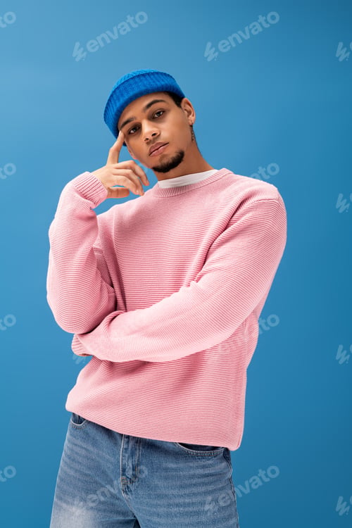 Preview: Handsome young man showcases current fashion trends with stylish outfit and vibrant backdrop