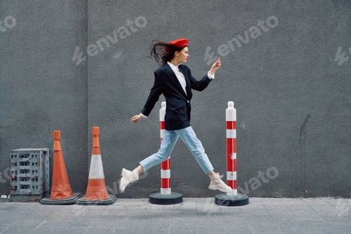 Preview: Fashion woman running down the street in front of the city tourist in stylish clothes with red lips