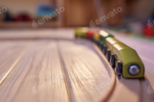 Preview: Wooden toy train on a track with defocused children's room in backdrop