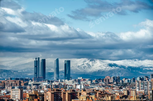 Preview: Madrid Skyline from the air, snowy in the background mountains