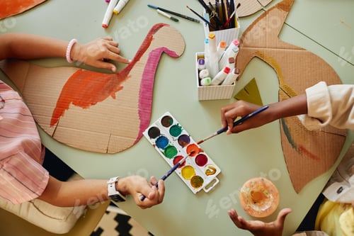 Preview: Top View at Group of Kids Painting Cardboard Dinosaur