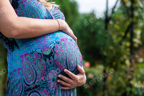 Preview: Pregnant woman holding belly