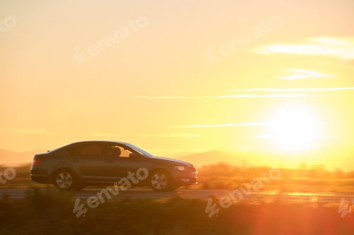 Preview: Car driving fast on intercity road at sunset. Highway traffic in evening.