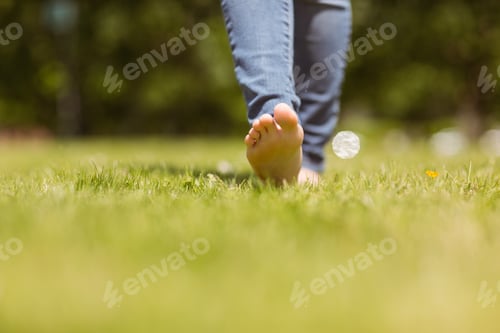 Preview: Close up of pretty redhead walking on grass at sunshine