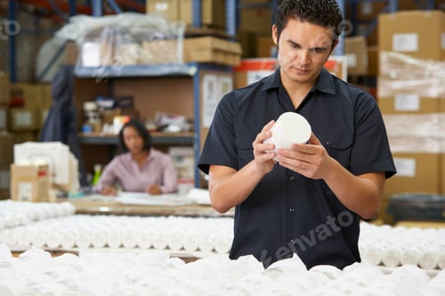 Preview: Factory Worker Checking Goods On Production Line