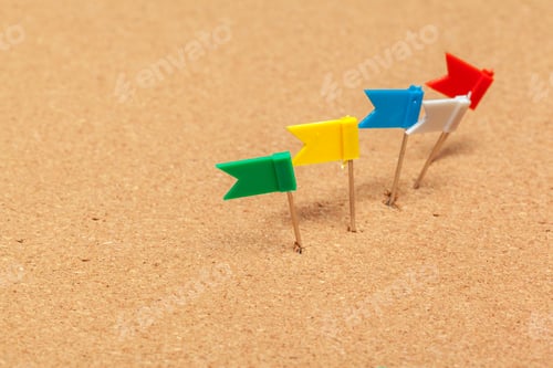 Preview: Mini flags thumbtacks over corkboard background close up