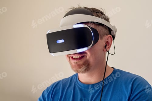 Preview: Happy bearded man wearing VR headset. Virtual reality technology. Gaming