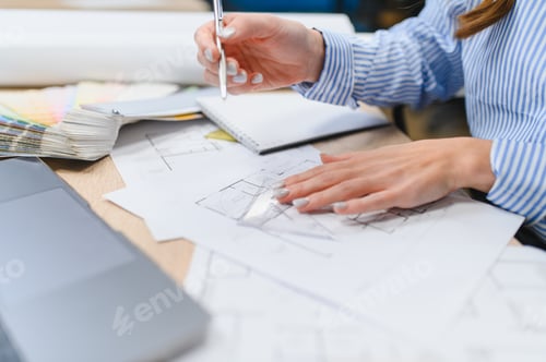 Preview: Woman designing architectural blueprint with color swatches