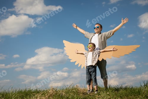 Preview: Father and son playing with cardboard toy wings