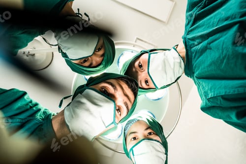 Preview: Professional medical team performing surgical operation in modern operating room.