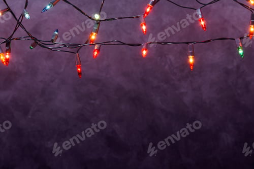 Preview: Christmas lights string on loft wall background with copy space