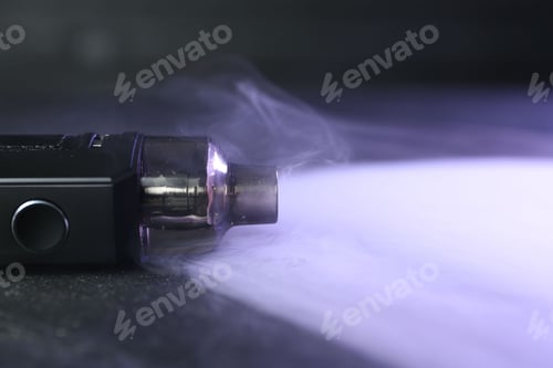 Preview: Modern electronic smoking device on black table, closeup. Space for text