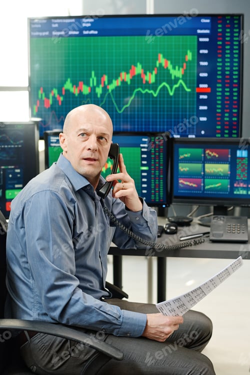 Preview: Mature Broker Talking On Phone
