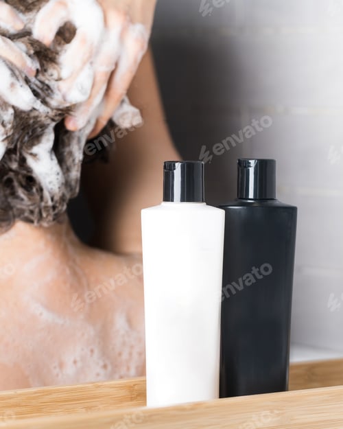 Preview: Shampoo, hair conditioner with a place for a logo on the background of a girl who washes her hair.