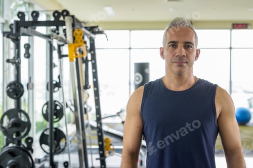 Preview: Portrait of mature handsome Persian man at the gym