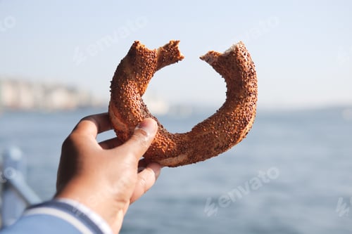 Preview: holding a Turkish Bagel Simit against istanbul city background