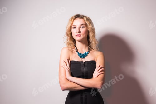 Preview: Portrait of sensual blond woman with curly hair over light grey background with copy space