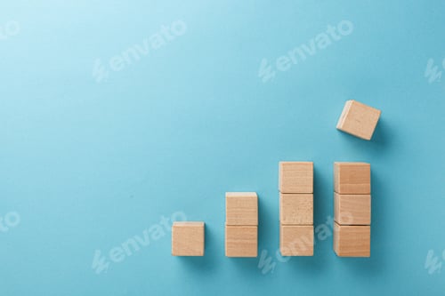 Preview: wooden cubes in the form of a ladder with a hand on a blue background