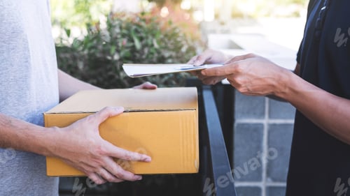 Preview: Delivery mail man giving parcel box to recipient