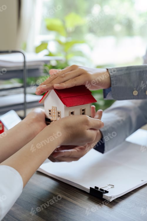 Preview: agent hand cover house model. real estate, insurance and property concepts after purchase