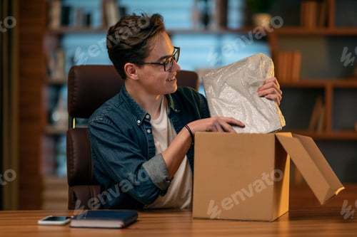 Preview: Happy young man customer got brand new laptop computer, office interior