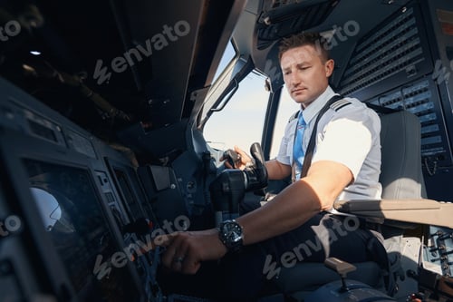 Preview: Man first officer pressing button on airplane control panel