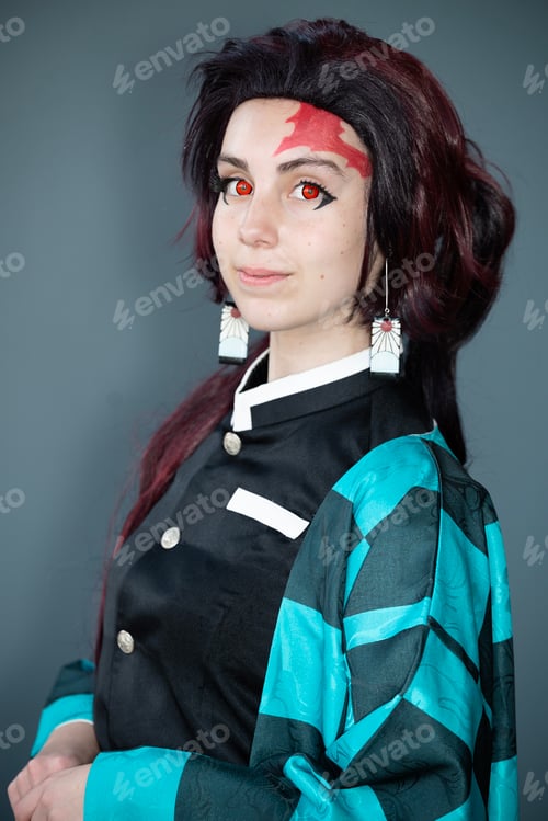 Preview: Caucasian female cosplayer in a blue costume with face paint and red contact lenses