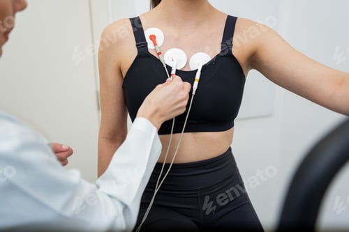 Preview: Young woman undergoing a fitness evaluation with professional assistance in a modern gym