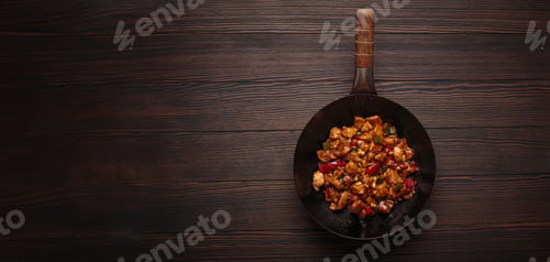 Preview: Traditional Chinese dish kung pao chicken in wok pan on wooden background top view