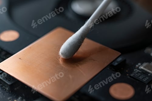 Preview: a macro view of removing dust from microprocessor board using the cotton bud