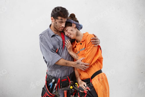 Preview: Repair, building, people and relationships concept. Young repairman wearing uniform trying to calm h