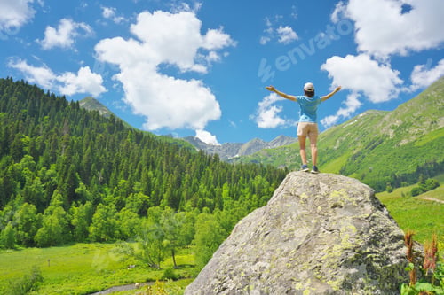 Preview: Woman enjoy mountian nature and spread your arms to sky
